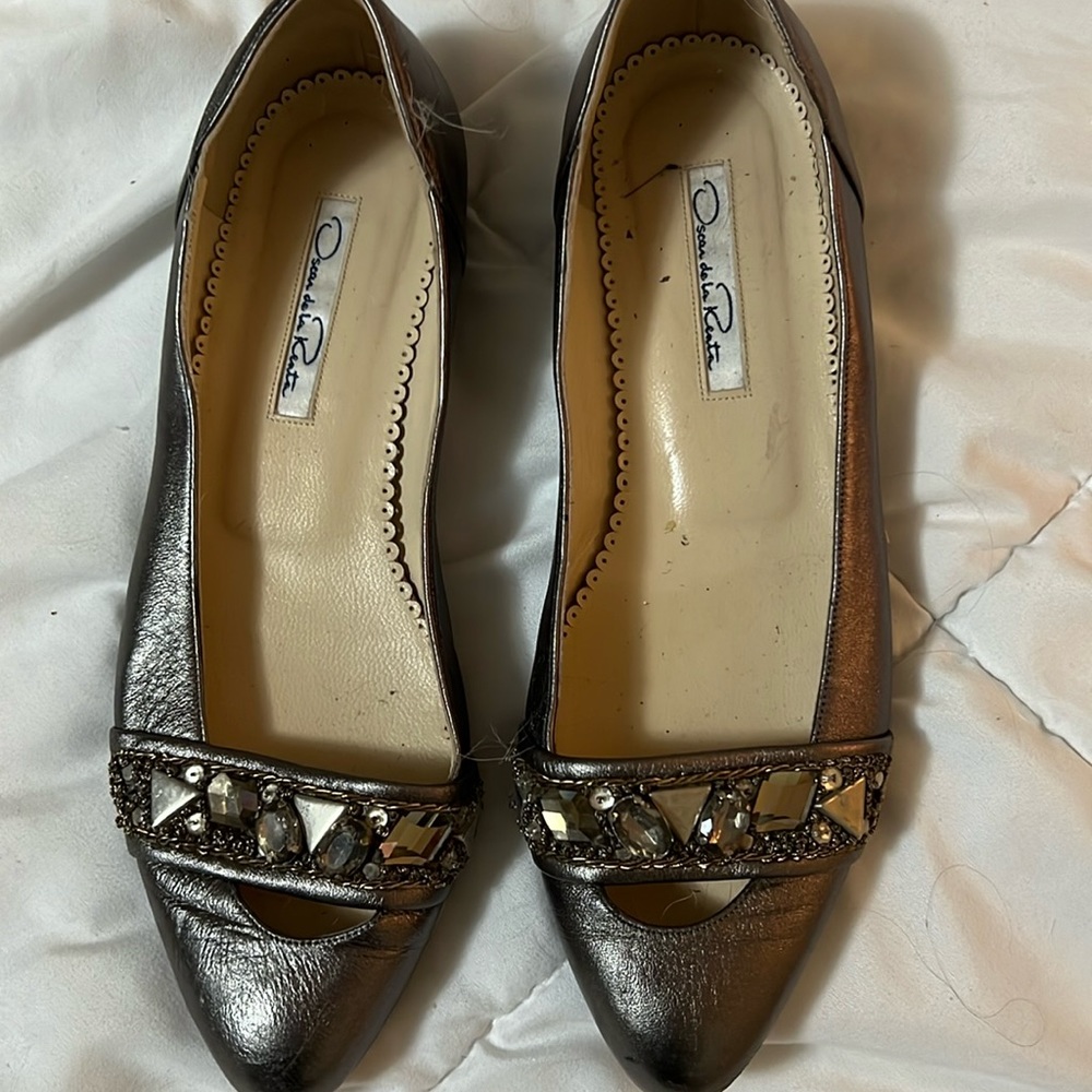 Flats with jewelry on front of shoe